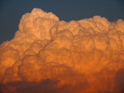 [Close-up of one portion of the seemingly thick, cotton-like clouds.]